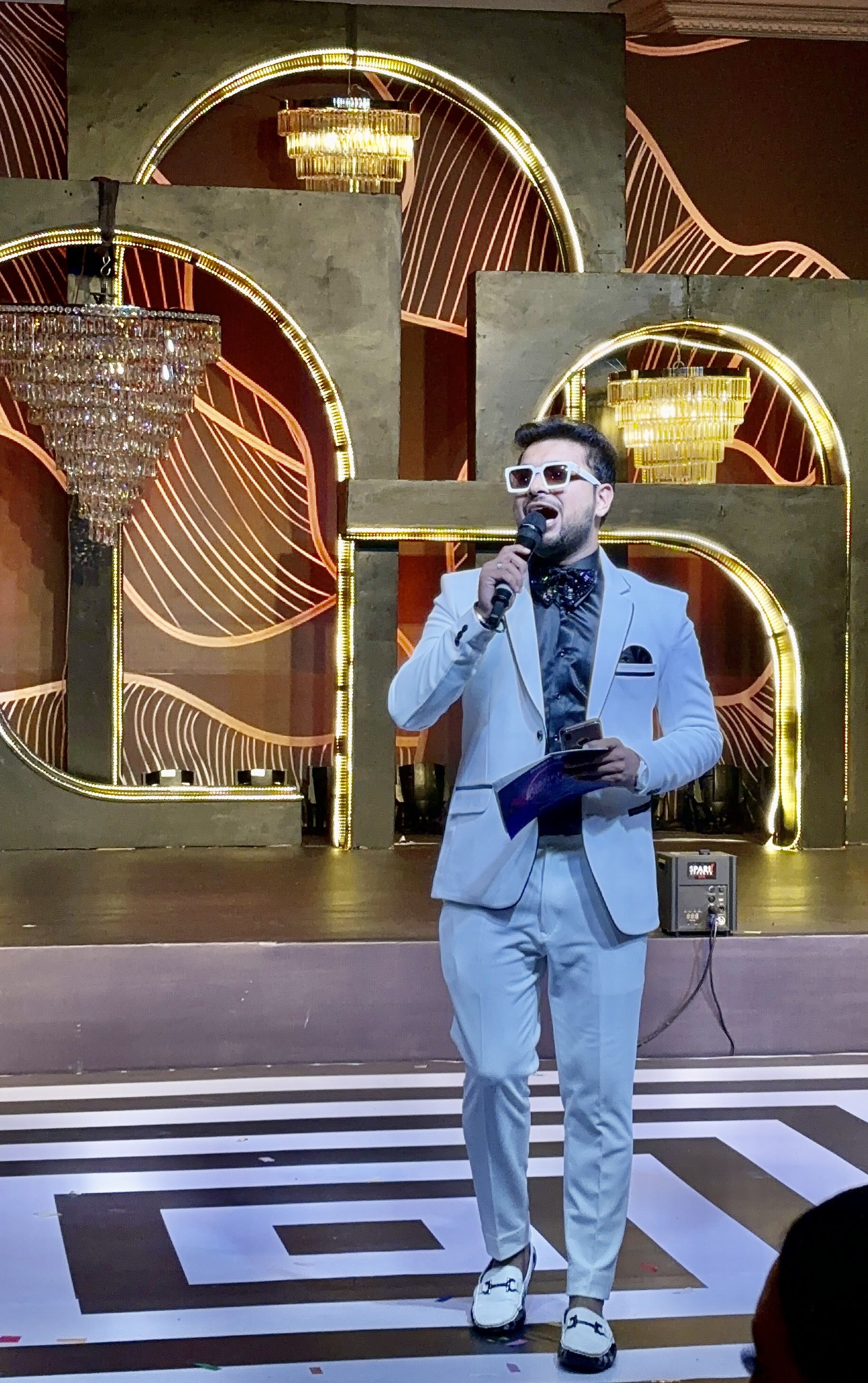 Pankhil Dholakia hosting a grand luxury wedding sangeet on a vibrant stage
